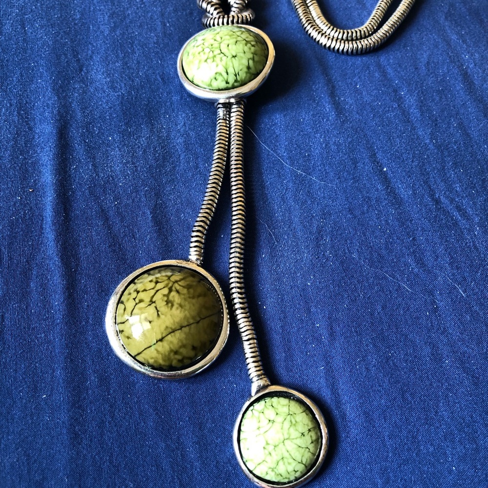 Long statement necklace with green triple pendant